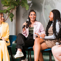 three women speaking at a panel event